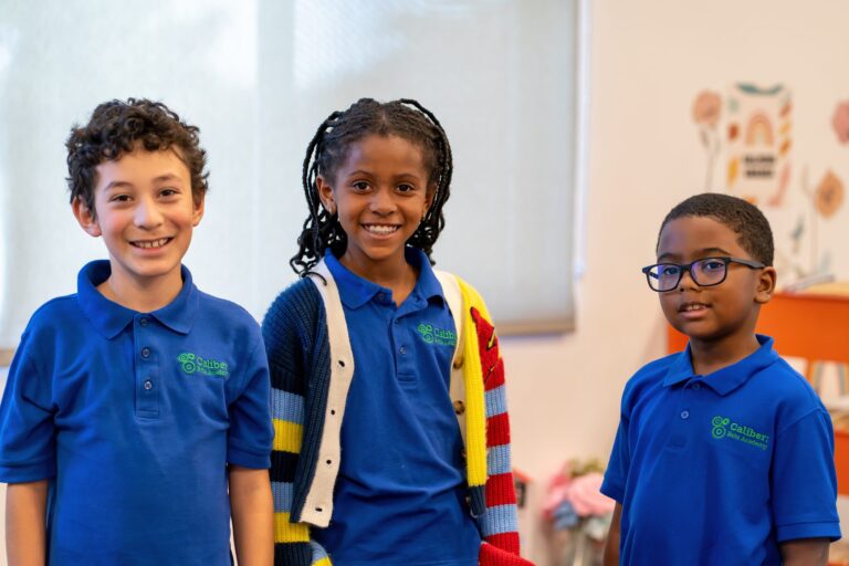 Caliber students smile as they pose for a photo