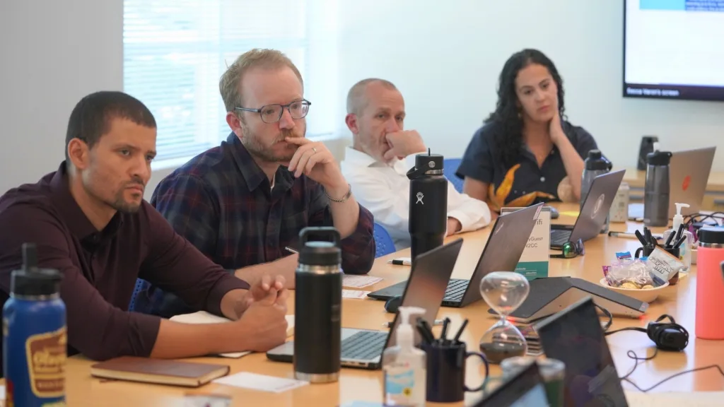 A Conversation with Michael Burks, CEF’s Director of School Partnerships 1 Michael Burks sits at a table with others during a teacher leader meeting.