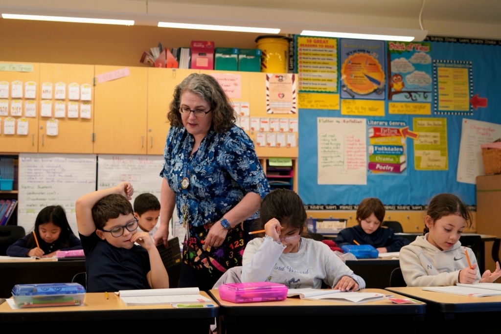 Ohlone Elementary Teacher Christine Moran With Students At Desk