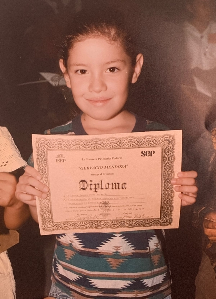 Priscilla Zamora Smiles Holding A Diploma