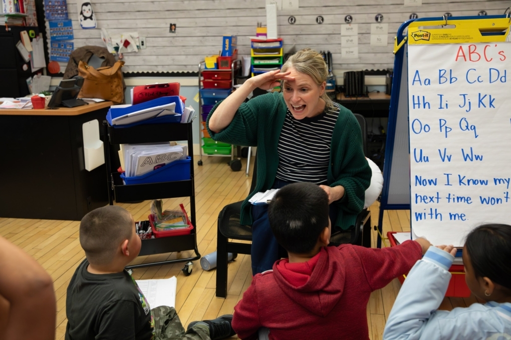 Teacher Teaching Students With Theme Leaping Forward In Literacy