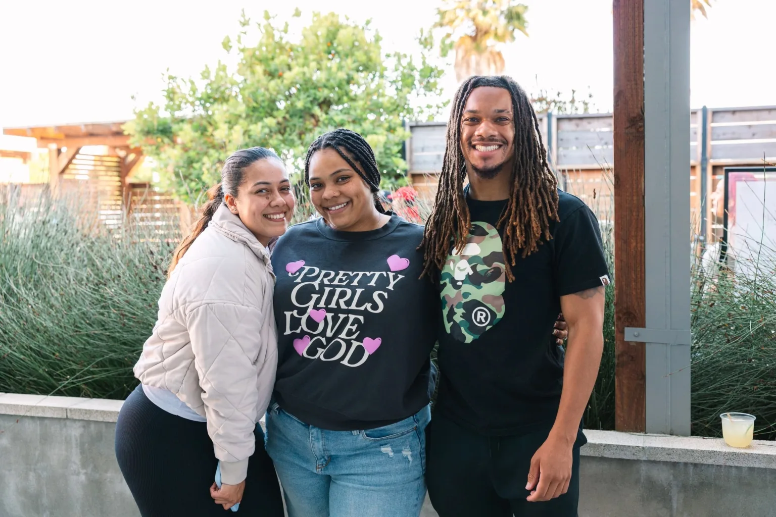 Teachers Jason, Randee and Rosalinda smile outside